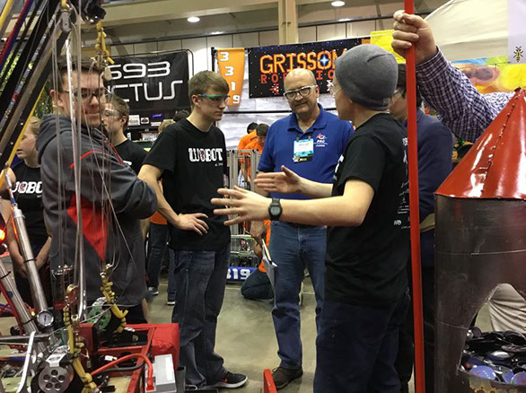 A group of students talking to the judges.