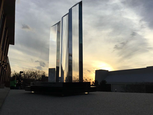 A picture of the trophy with the sunset.