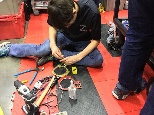 Eliot working hard on wheel brackets.