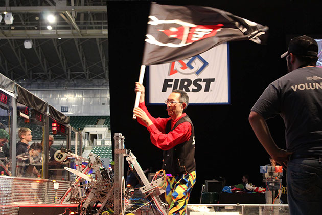 The MC waving our flag while introducing our team during a match