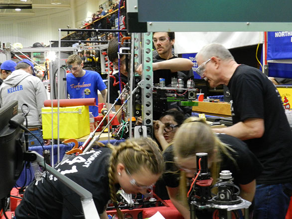 Pit crew working on checks between matches.