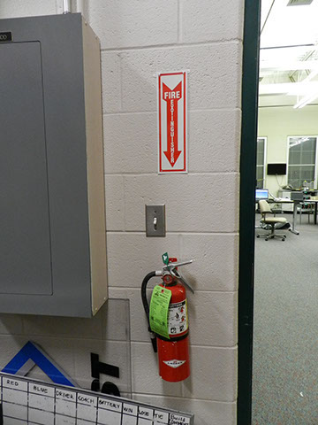 Fire extinguisher conveniently located outside of the Design+Build Room