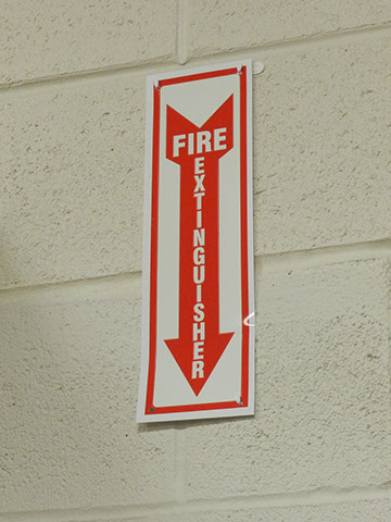 Every Fire extinguisher has a sign above it that are visible at all angles