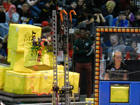 A close up of our robot putting a cube on the scale.