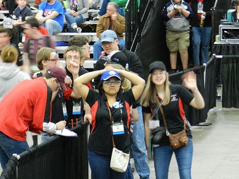 The team strategizing and then looked up at the stands and waved hello during a time out.