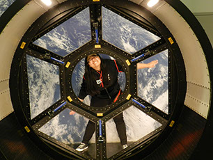 Smile. Cayla is between the view from the space craft and earth.