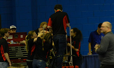 The pit crew working very fast between the final matches.