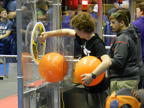 Our human player working on sending a piece of cargo (kick ball) through the loading station to the robots.