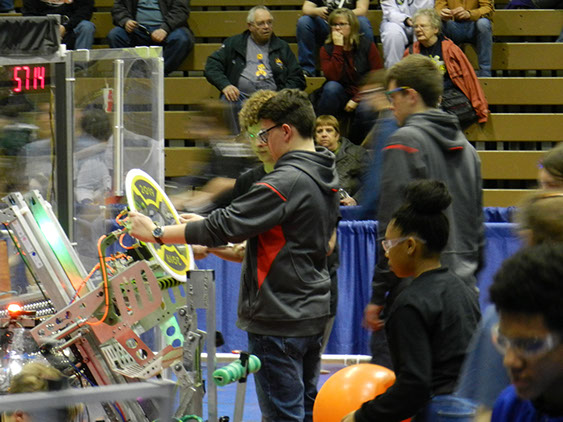 The team setting up the robot by pre-loading a hatch piece before the match starts