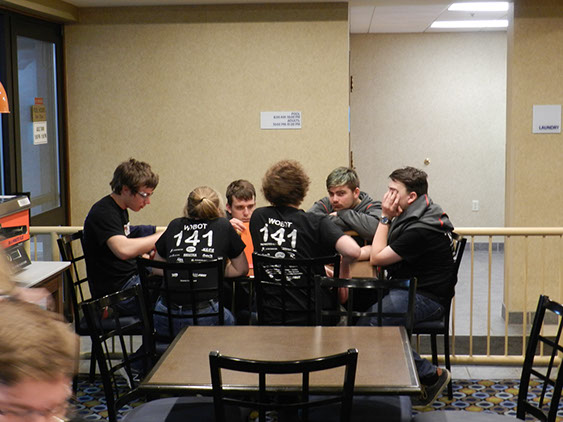 Drive team strategizing up coming matches after a long and tiring day.