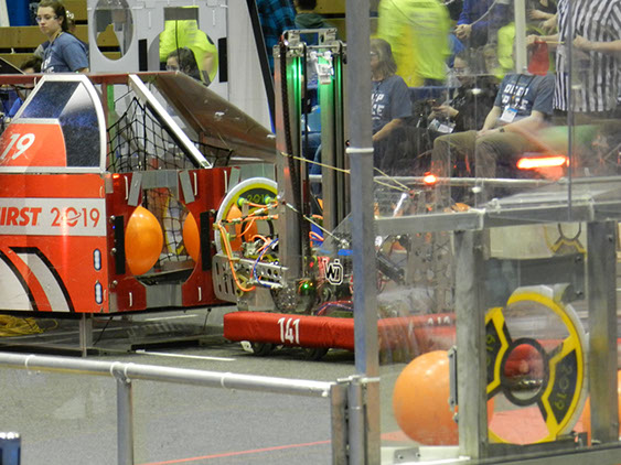 A picture of our robot sticking a hatch to the cargo ships Velcro strips.