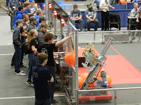 One of our human players feeding a piece of cargo to our robot