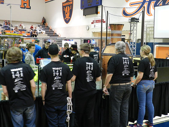 Watching the team while calibrating the robot on the field