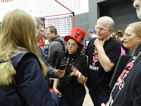 The team  talking to visitors with an Engineering  Scavenger Hunt for a homework assignment.