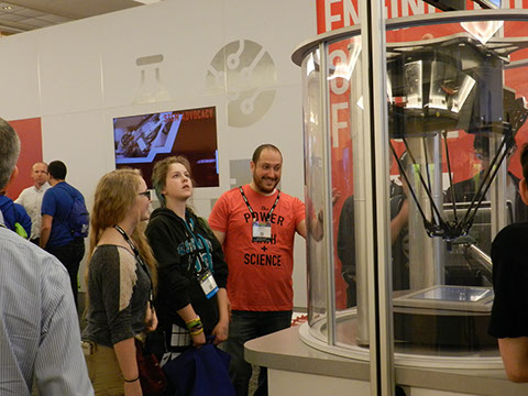 A couple of the students looking at a display of robotic devises at the Innovation Fair.