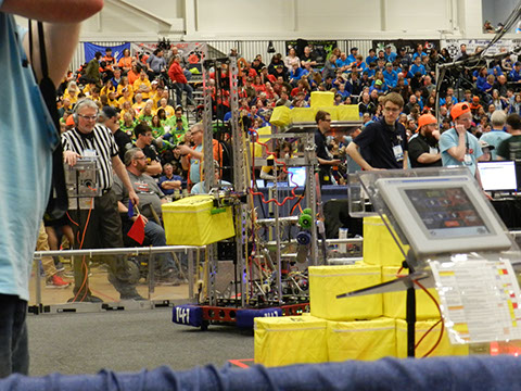 Our robot grabbing a cube and working it's way to one of the scales.