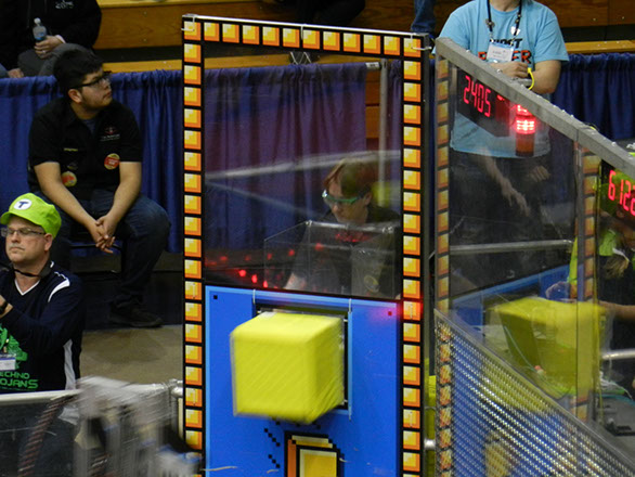 Matthew, another Human Player, is pushing the cube out the portal for one of our alliance robots.