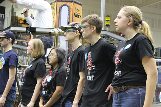 The drive team standing on the field ready to shake hands before the final match.