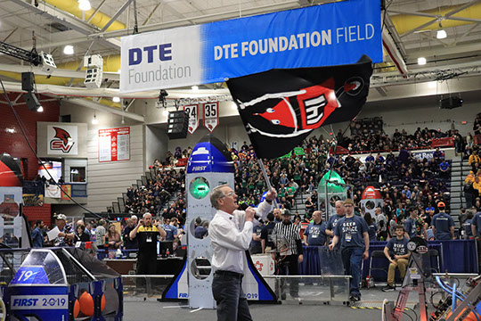 One of the MC's waving our flag while introducing our team before a match