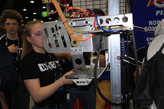 The students running through a check of the robot between matches