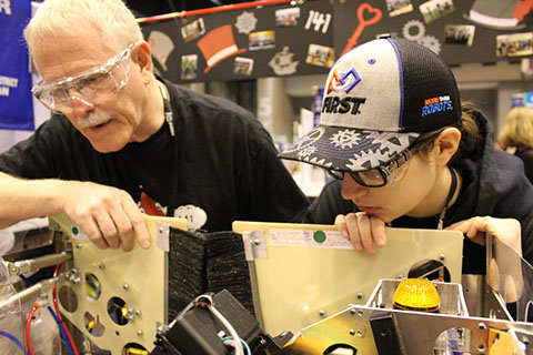 Bob and  Taylor checking the robot over.