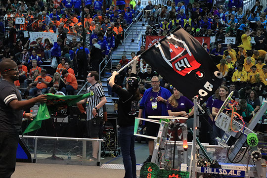 One of our students getting to fly our flag during the introduction before a match.