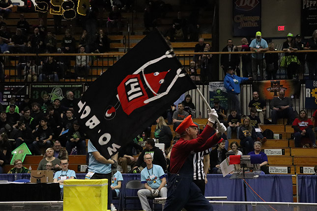 The MC waving our flag while announcing our team!