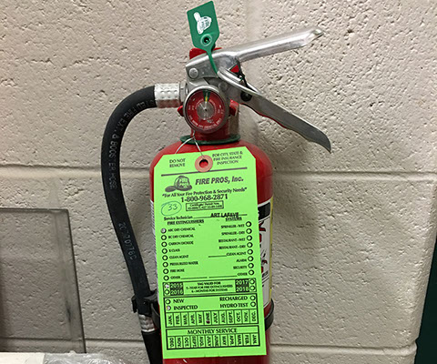 Fire extinguisher conveniently located outside of the Design+Build Room