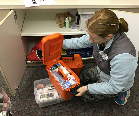 Student displaying contents of a FIRST Aid kit in the Design+Build Room